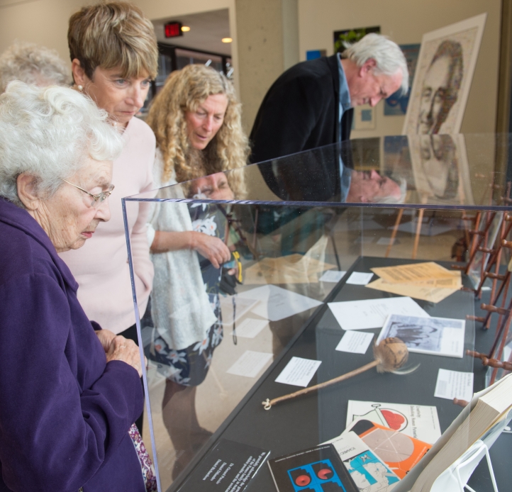 Bea Parnes looking at the display case for Sid. In the background their daughter Sue Parnes and husband Bill