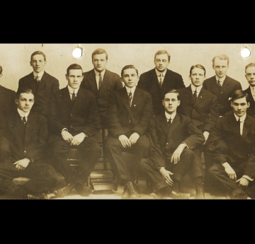 Osborn sitting in the middle of a group of men 