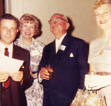 Parnes and Osborn smiling with two women at a conference