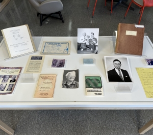 Table of books and photos of Sid Parnes, Ruth Noller, and Alex Osborn 