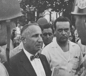 Fine standing with people at Little Rock high school taking notes