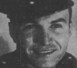 Decker smiling at camera with military hat on