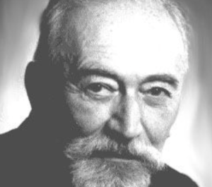 Moses Hadas smiling in black and white headshot 